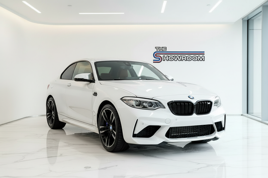 White BMW M2 Competition right-hand drive in showroom
